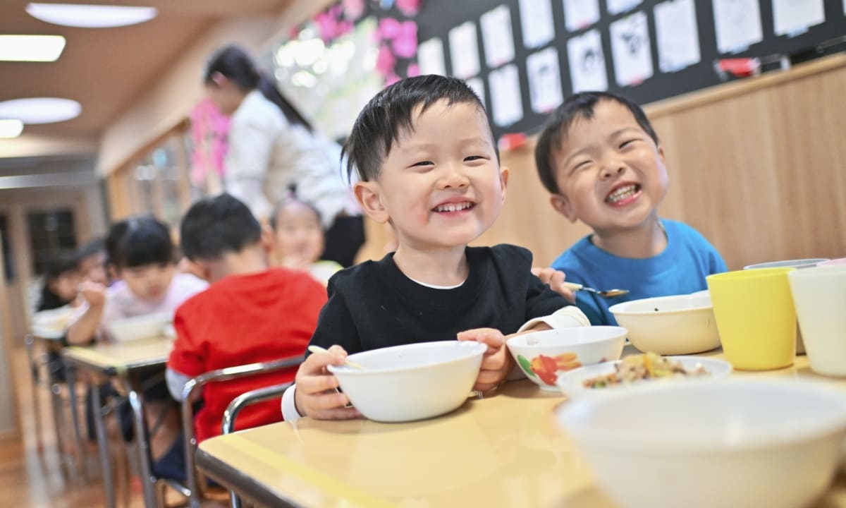 笑顔で食事をする子供の写真